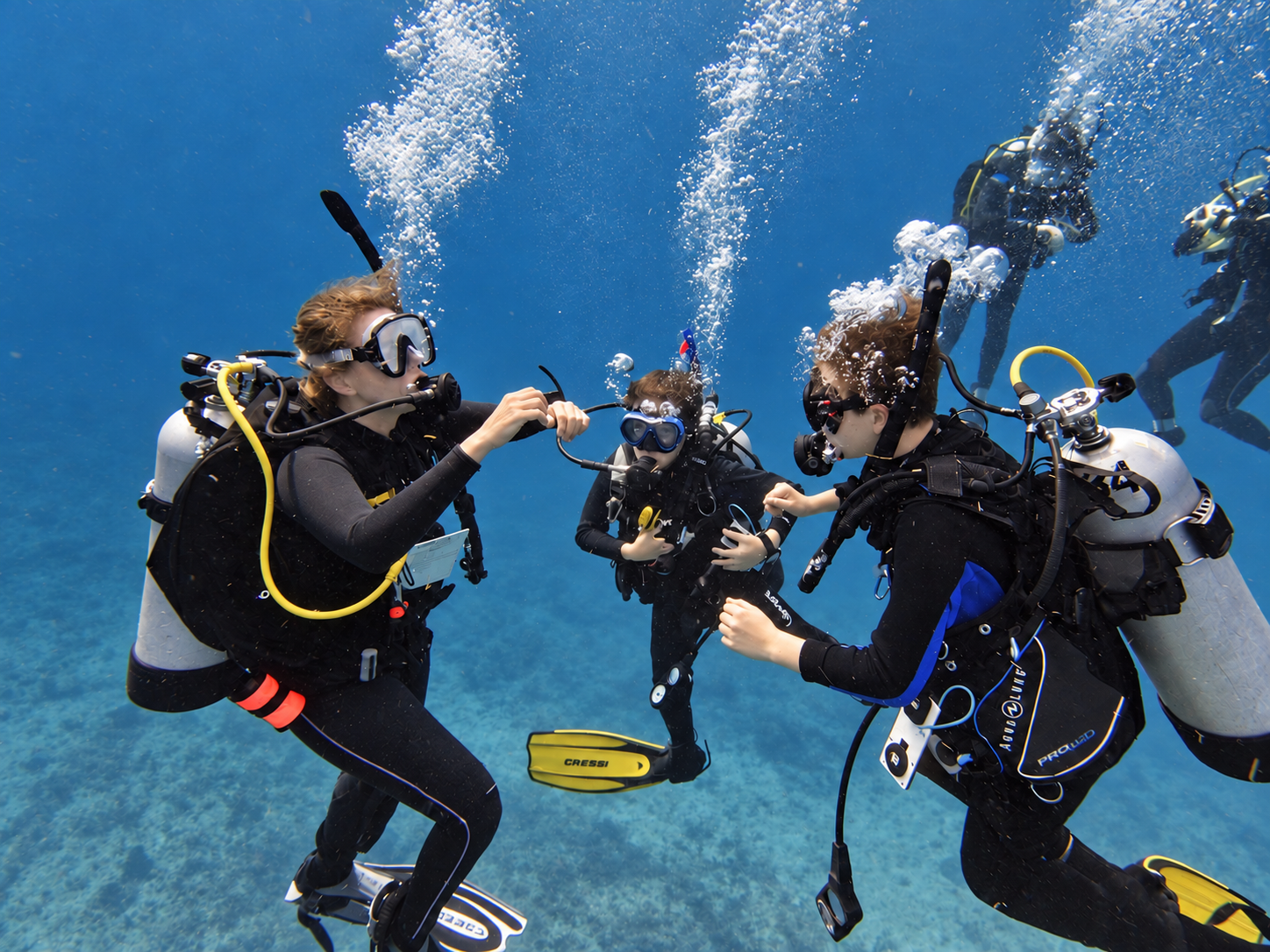 Divers together underwater practicing scuba skills